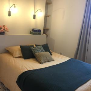 a bedroom with a bed with two pillows on it at Domaine Sesquier Mas d'exception Iris in Mèze