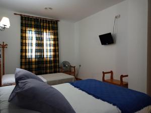 En eller flere senge i et værelse på Alojamiento Árdales