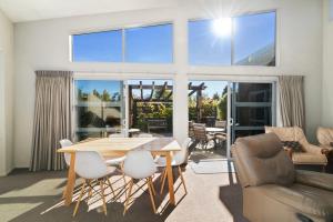 ein Wohnzimmer mit Tisch und Stühlen in der Unterkunft Hikuwai Family Retreat - Albert Town Holiday Home in Wanaka
