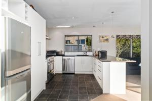 A kitchen or kitchenette at Hikuwai Family Retreat - Albert Town Holiday Home