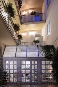 a room with tables and chairs in a building with stairs at Cas'E Charming House in Caserta