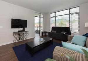 a living room with a couch and a tv at Lower Lonsdale Aprtment in North Vancouver