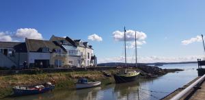 a group of boats docked in the water next to houses at Port Haverigg Marina Village in Millom