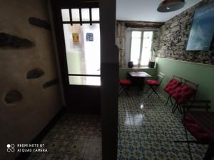 a room with a table and chairs and a window at Casa Apilladeira in Puentedeume