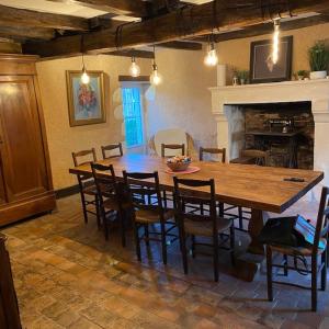 a dining room with a large wooden table and chairs at La Fermette Aux Canards in Savigny-Lévescault +20 photos