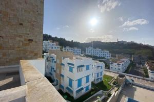 a view of a city with white buildings at Nice 1BR Salon Seaview Pool Mdiq Cabonegro in M'diq