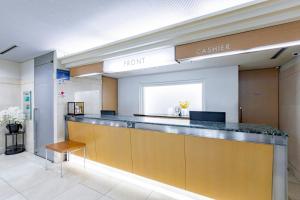 a lobby with a reception counter in a clinic at Kanazawa Central Hotel Annex in Kanazawa