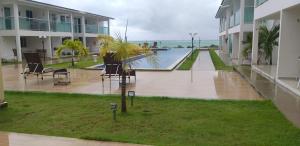 a pool in the middle of a building at Bangalô/Dúplex Jacumã Conde in Jacumã