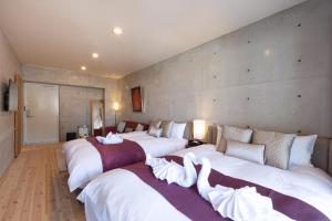 a group of four beds in a room at Tamatsukuri Daifuji Kan in Osaka