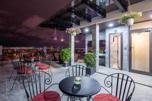 a patio with tables and chairs and a bar at Tan Phuong Nam Hotel & Apartment in Da Nang