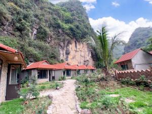 a row of houses in front of a mountain at Trang An Peaceful Homestay in Ninh Binh