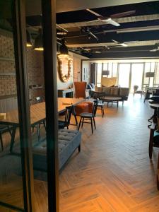 a dining room with tables and chairs and a room with tables and chairs at Just Sleep Tainan in Tainan