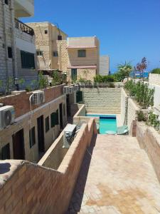 a swimming pool on the side of a building at no 4and5 Basement Chalets 2 Beds Green Beach on the pool 114b in El Alamein