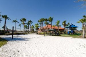 a beach with palm trees and a playground at Serene Refuge rent rooms not whole house in Davenport