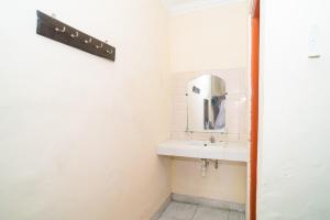 a bathroom with a sink and a mirror at RedDoorz near Kampus 3 UTY Yogyakarta in Yogyakarta +56 photos