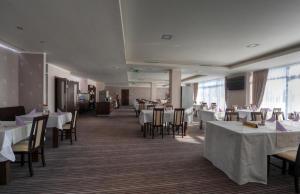 a dining room with white tables and chairs and tablesearcher at Apartmany Panorama 10X-90X in Štrbské Pleso