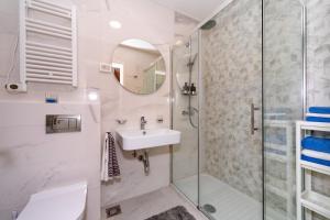 a bathroom with a sink and a shower at Les appartements Privés Bar in Bar +56 photos