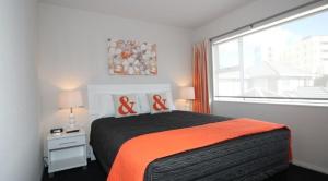 a bedroom with a bed and a large window at Carramar Motor Inn in Palmerston North