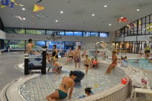 een groep mensen in een zwembad bij Summer house on the Dutch coast in IJmuiden