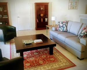 a living room with a couch and a coffee table at Angaston Lodge in Angaston