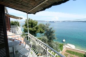 a balcony of a house with a view of the water at Apartments Marta in Trogir