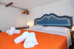 a bedroom with a bed with towels on it at Casa Saraceni (by Vacation Service) in Cefalù