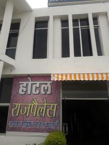 un edificio blanco con un cartel en la parte delantera en Vamoose Raj Palace, en Bharatpur