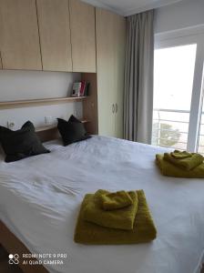 a bedroom with a bed with two towels on it at IDEAL TOWER DUIN EN ZEE in Blankenberge
