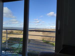 a view of the beach from a window at IDEAL TOWER DUIN EN ZEE in Blankenberge