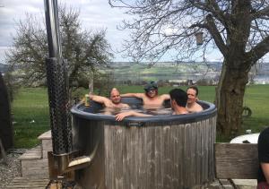 a group of men in a hot tub at B&B Friedau in Nottwil