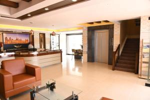 a lobby of a hotel with a chair and a table at ADVAITHA RESIDENCY in Mysore