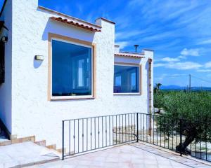 a house with a large window on the side of it at villa immersa in oliveto vista mare in Sciacca