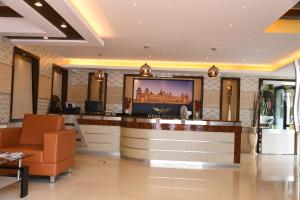 a hotel lobby with a reception desk with a tv at ADVAITHA RESIDENCY in Mysore