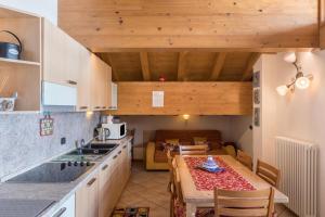 a kitchen with a table and a dining room at Nadir - Casa Azzurra in Livigno +20 photos