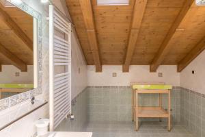 a bathroom with a sink and a wooden ceiling at Nadir - Casa Azzurra in Livigno