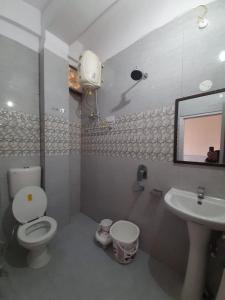 a bathroom with a toilet and a sink at CITY CROWN GUEST HOUSE in Sundarnagar