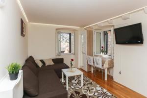 a living room with a couch and a table at Old Town Princess Apartments in Dubrovnik