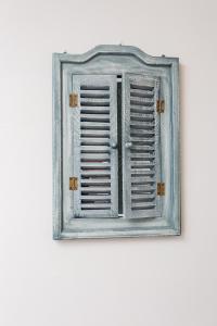 a window in a blue frame on a white wall at Old Town Princess Apartments in Dubrovnik