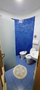 a blue tiled bathroom with a toilet and a sink at Villa "GREEN PARADISE" in Divjakë +39 photos