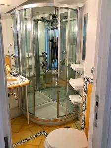 a glass shower in a bathroom with a toilet at Villa Guya in Capri