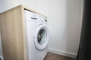 uma máquina de lavar roupa branca num quarto com um balcão em ATIC PORT EXPERIENCE em Tarragona