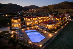 a large mansion with a swimming pool at night at Costa D' Ifesto in Agios Ioannis Kaspaka
