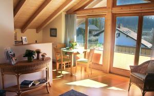 a living room with a table and a large window at Bergblick in Garmisch-Partenkirchen