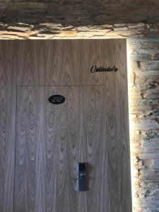 una puerta de madera con la palabra orquestación en ella en A Casa da Botica en Samos