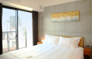 Uma cama ou camas num quarto em Yoshitsuki kaku - Yoshitsuki Apart Hotel