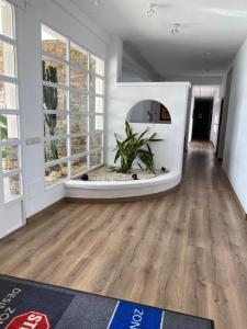 a living room with wooden floors and a large window at Hotel Venta del Pobre in Níjar