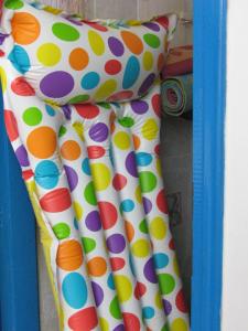 a pair of polka dot curtains in a blue frame at Family house by the seaside of Karavostasis in Karavostasi