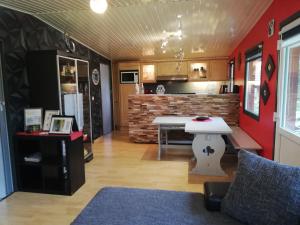 a living room with a table and a kitchen at Titi's Chalet in Durbuy