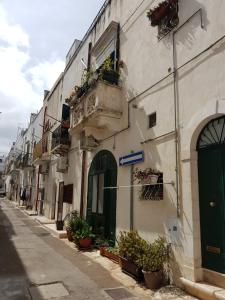 a building with plants on the side of a street at Casa Meravigliosa in Ostuni