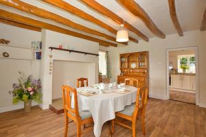 a dining room with a white table and chairs at Finest Retreats - Shortflatt Farm Cottage in Belsay